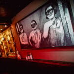 Picture on wall of three girls with masks