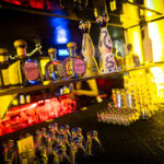Wall of bottles behind bar