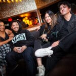 People smiling with drinks in hand