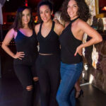 Three girls standing and smiling