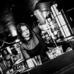 Female bartender pouring drinks